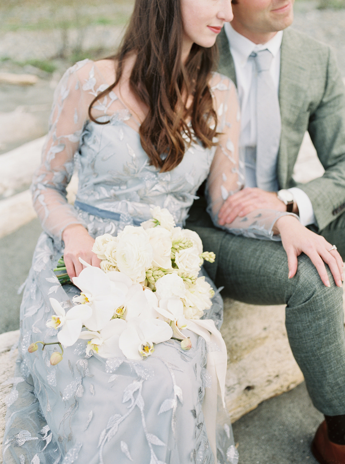 Couple sitting on driftwood