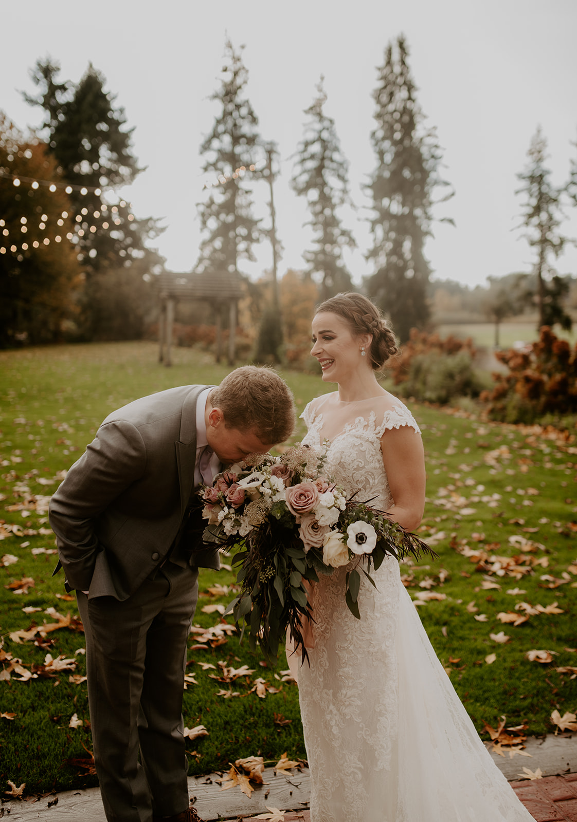 The groom stopping to smell the bride's flowers