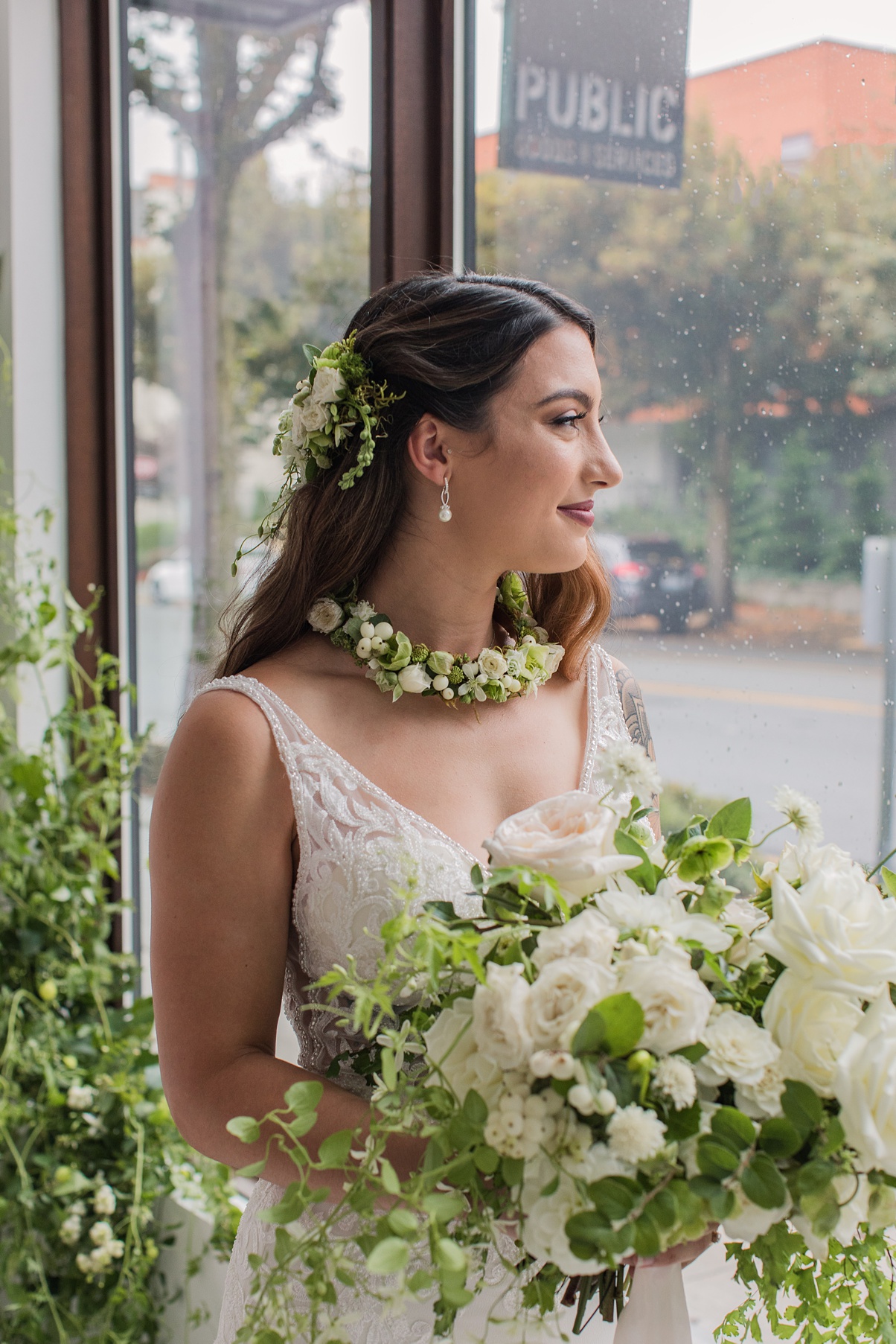 Modern-White-Wedding-Bride-Holding-Bouquet-by-Window Bride holding white bouquet and looking out window
