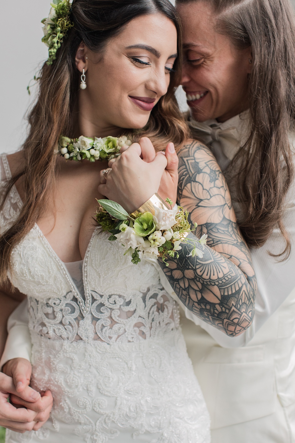 Modern-White-Wedding-Brides-Embracing Brides embracing on their wedding day