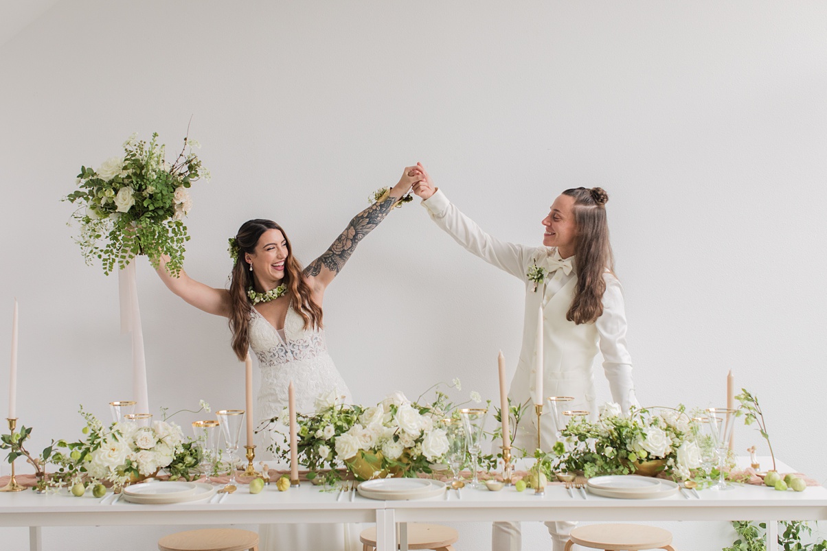 Modern-White-Wedding-Holding-Hands-Dancing Brides holding hands and dancing after their ceremony