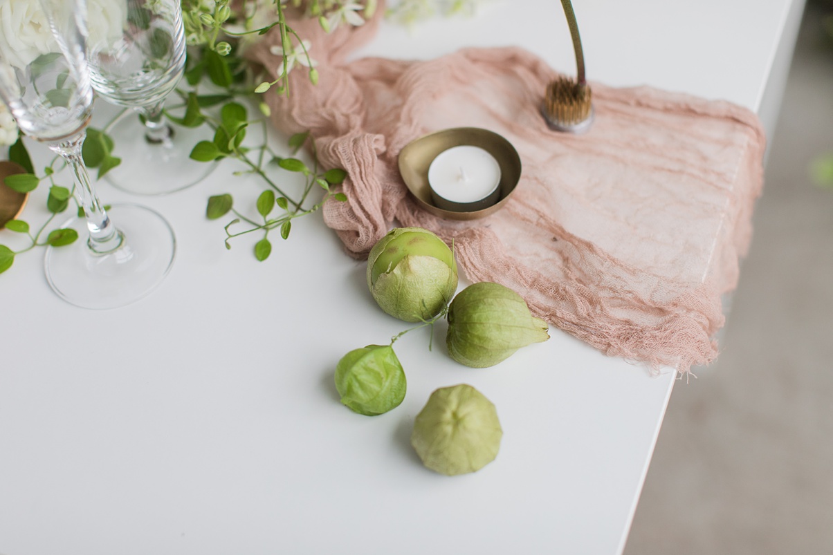 Modern-White-Wedding-Table-Details Table details with table runner, candles, and tomatillos