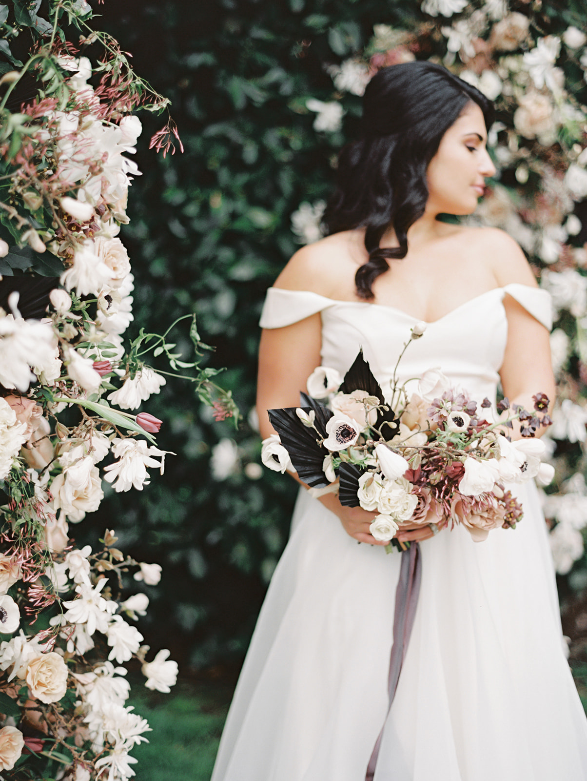 Seattle-Wedding-Florist-Bloom-Poet-Floral-Design-Bridal-Bouquet A bride holding a wedding bouquet with anenomes, roses, and tulips