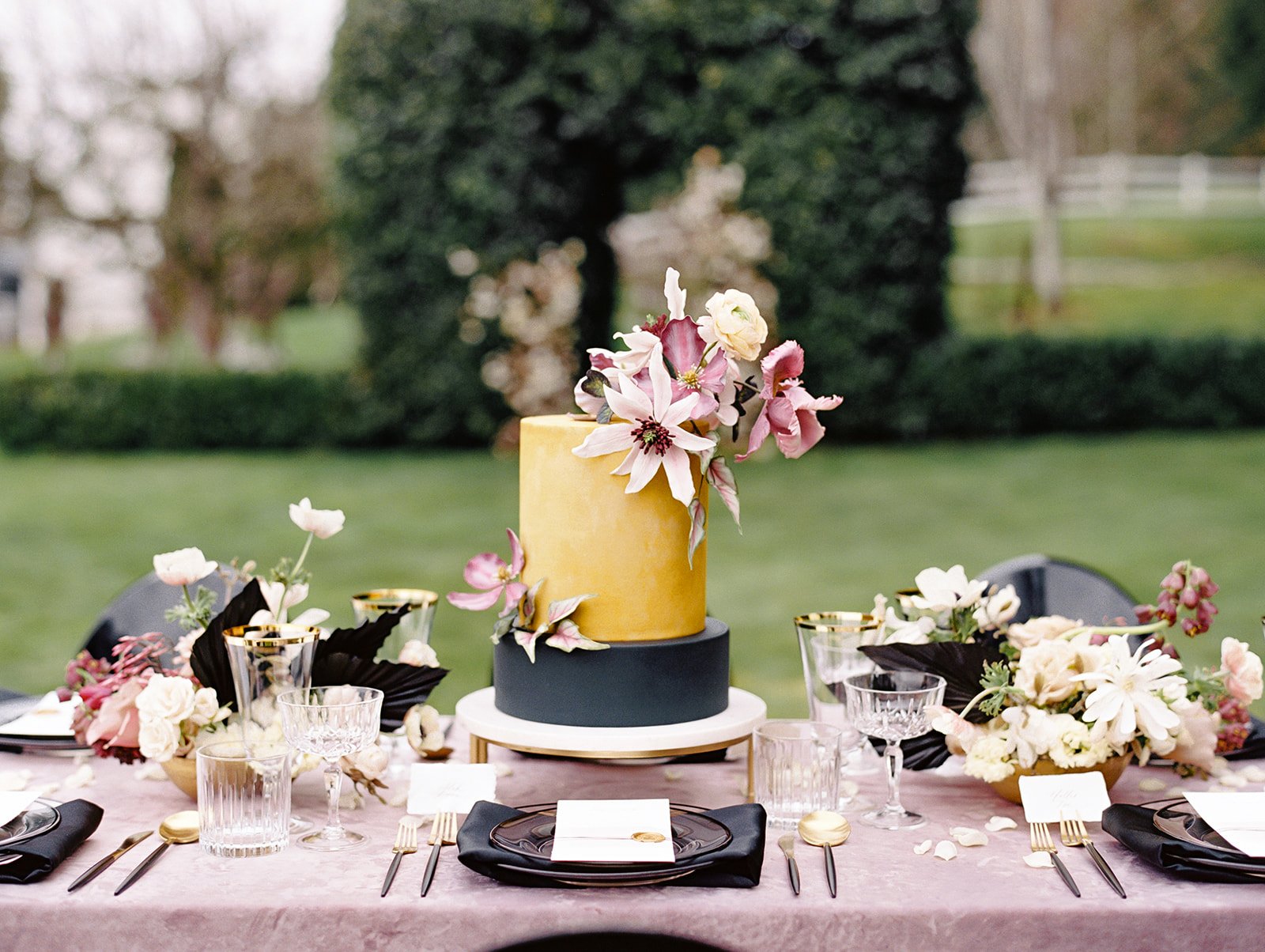 Seattle-Wedding-Florist-Bloom-Poet-Our-Services-Cake-Table-Setting.jpg a table set with velvet linen, a cake with sugar flowers, and floral centerpieces