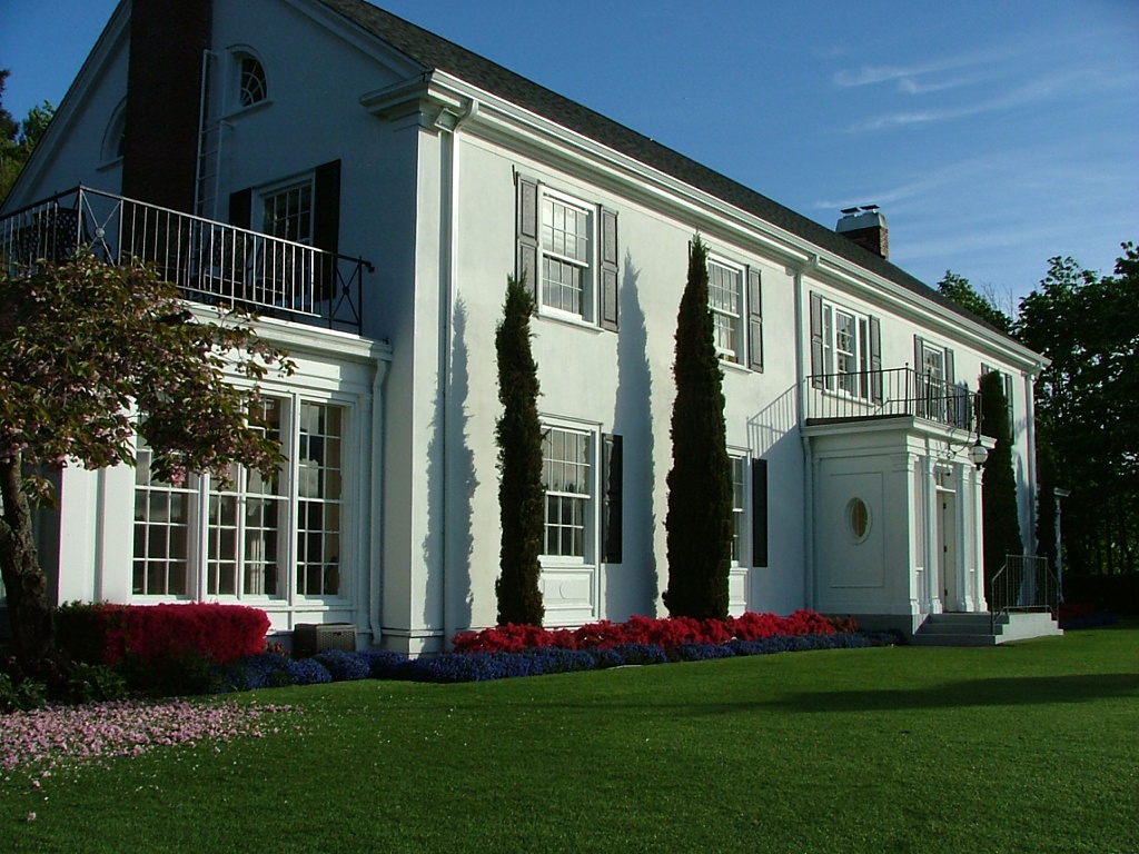 The Admiral's House, on a clear blue sky day with beautifully manicured lawn and gardens