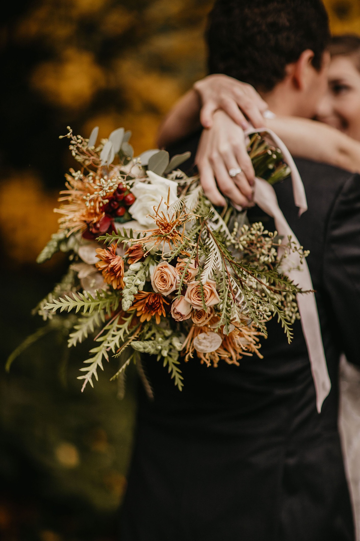 a seasonal wequet with roses, heirloom mums, grevillea foliage, and orchidsdding bou