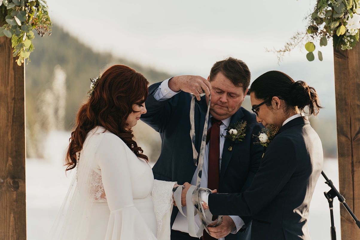 Winter-Destination-Wedding-Mountain-Springs-Lodge-Handfasting-Ribbon The botanical print hand-dyed silk ribbon being used in handfasting ceremony