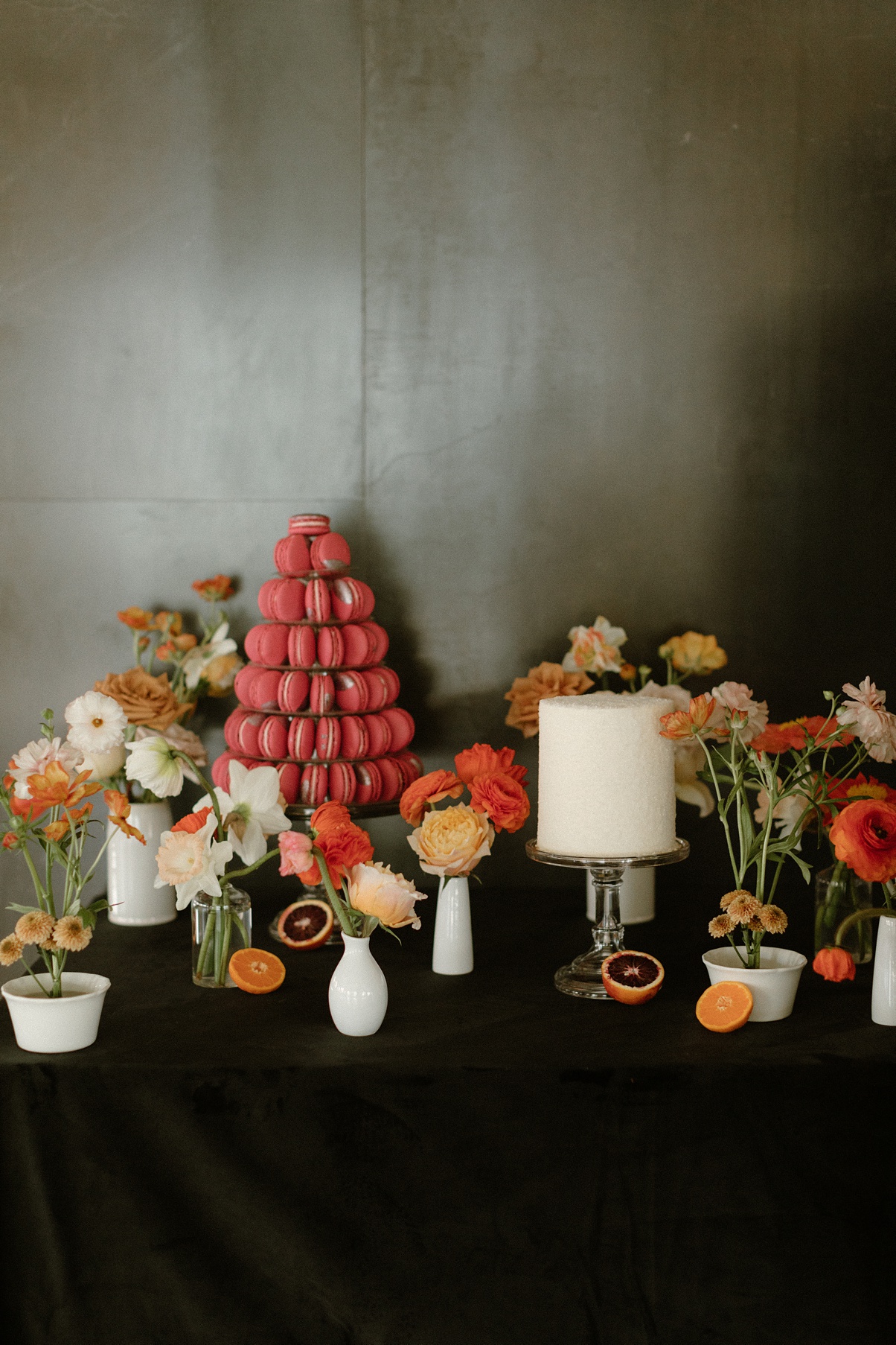 Block 41 wedding cake table with cake, macarons, and of course flowers