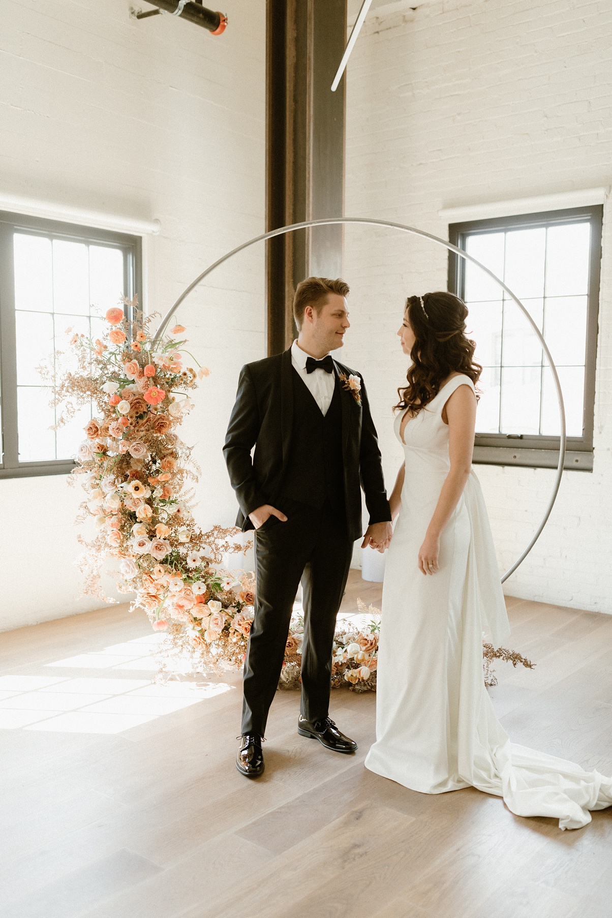 Block 41 wedding ceremony arch florals with couple standing in front