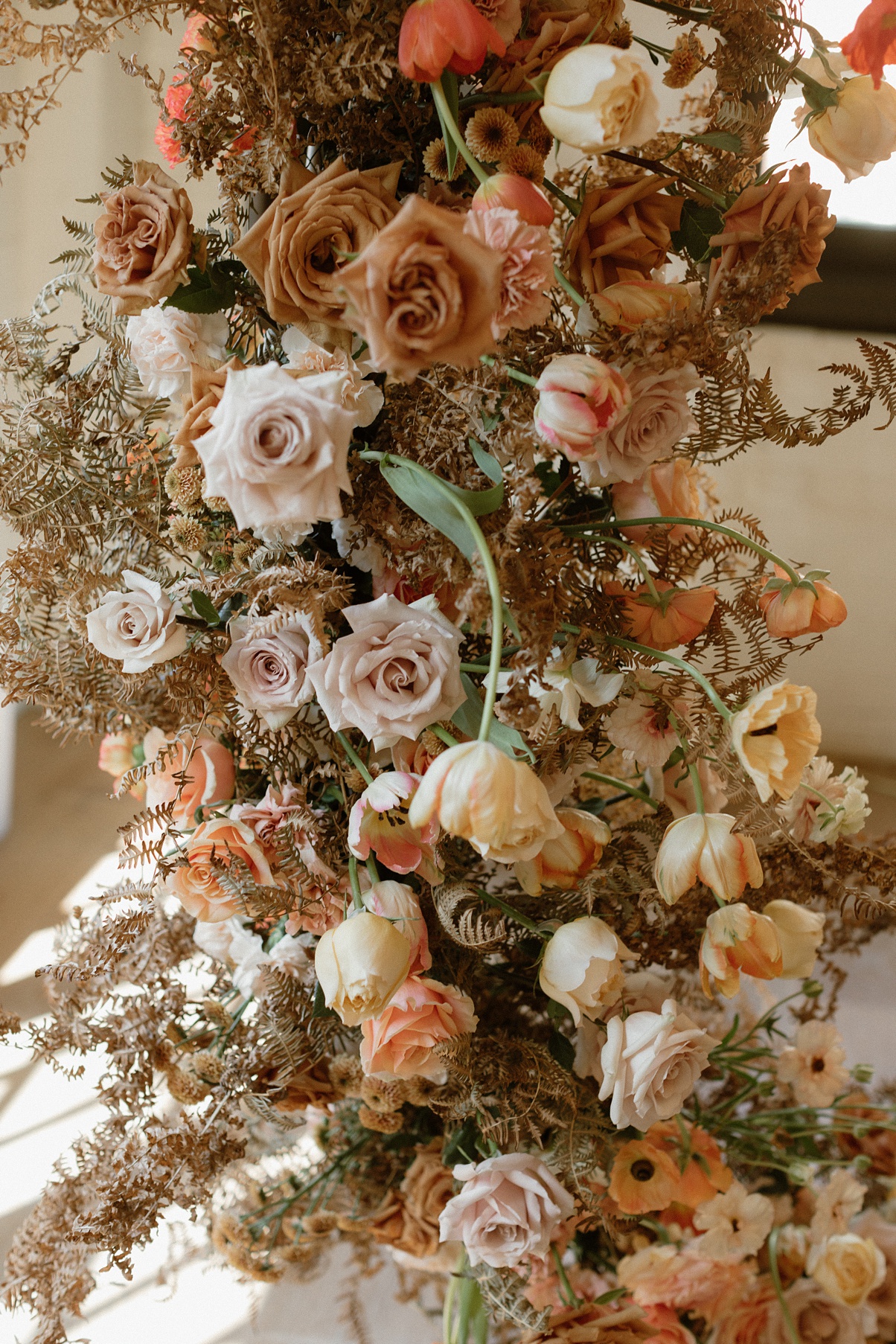A closeup of the floral arch for this Block 41 wedding with roses, tulips, and more