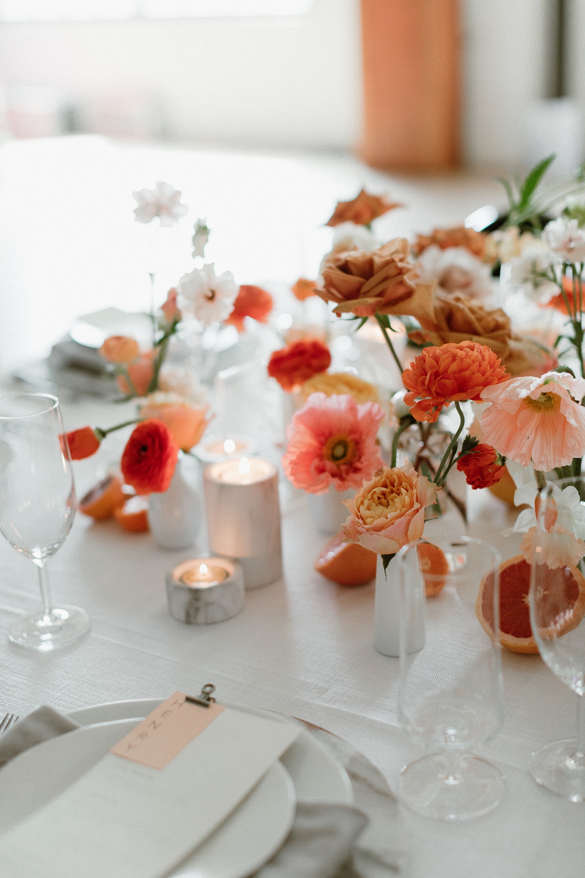 Block 41 wedding head table details with flowers, candles, and place settings