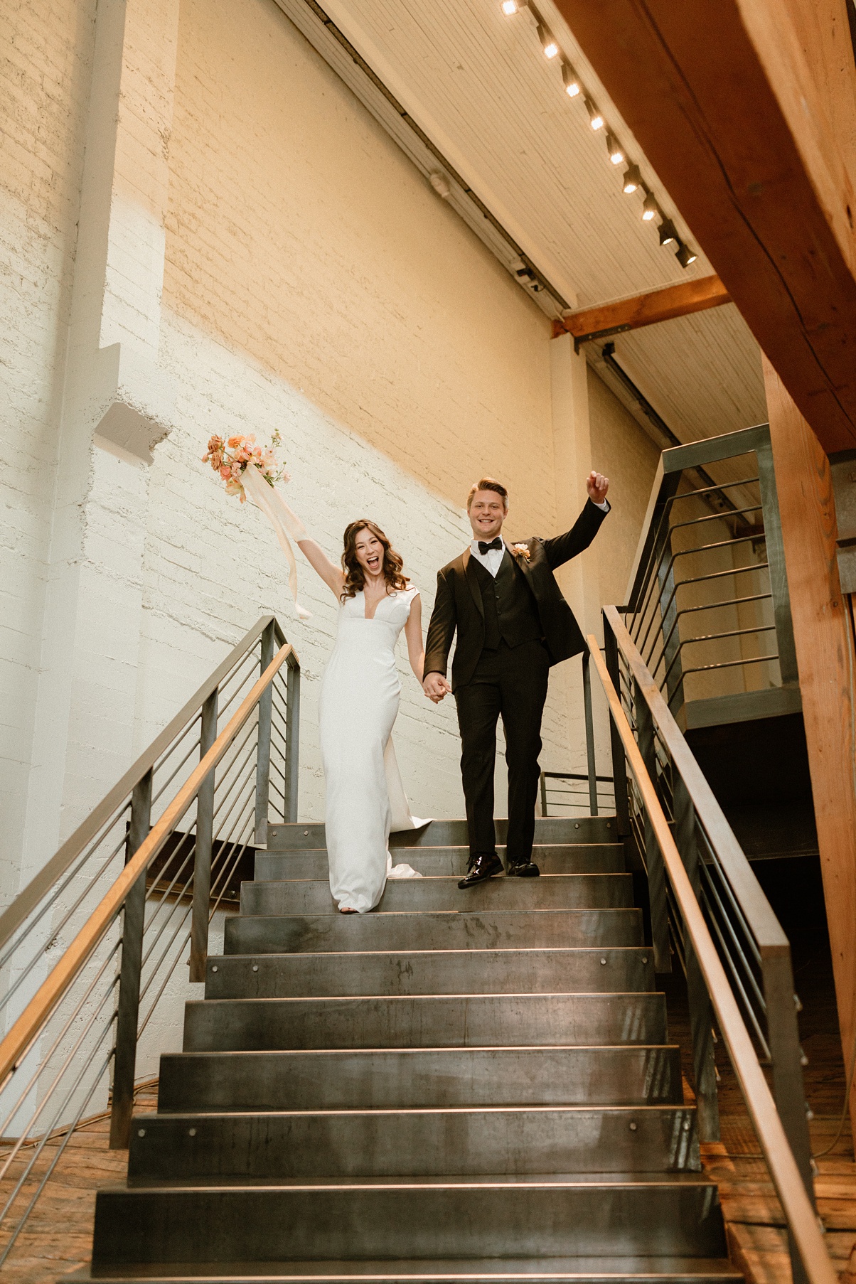Couple walking down stairs at Block 41 wedding reception
