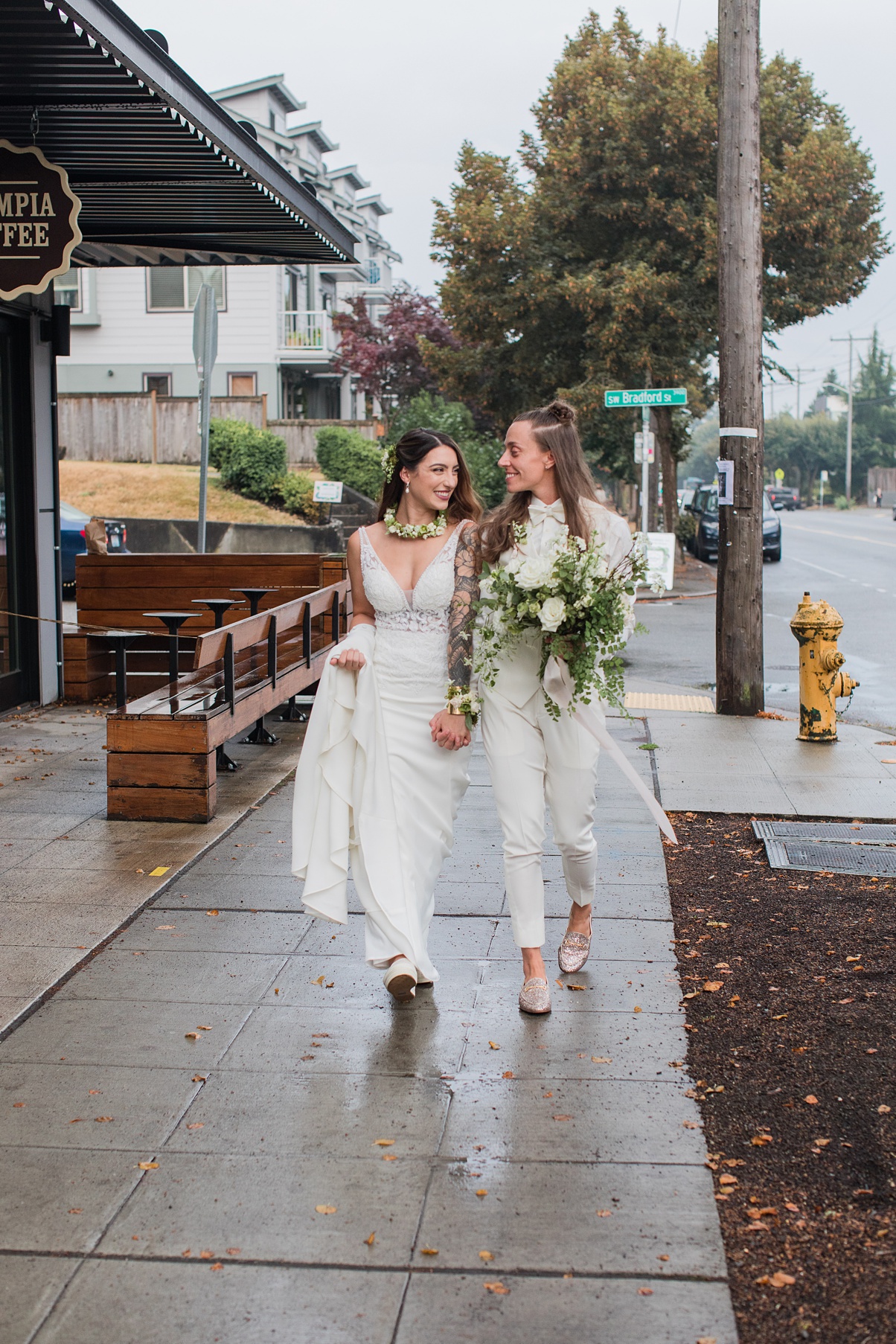 Modern-White-Wedding-Couple-Walking-Outdoors-Seattle A queer couple walks outdoors in Seattle holding hands after wedding