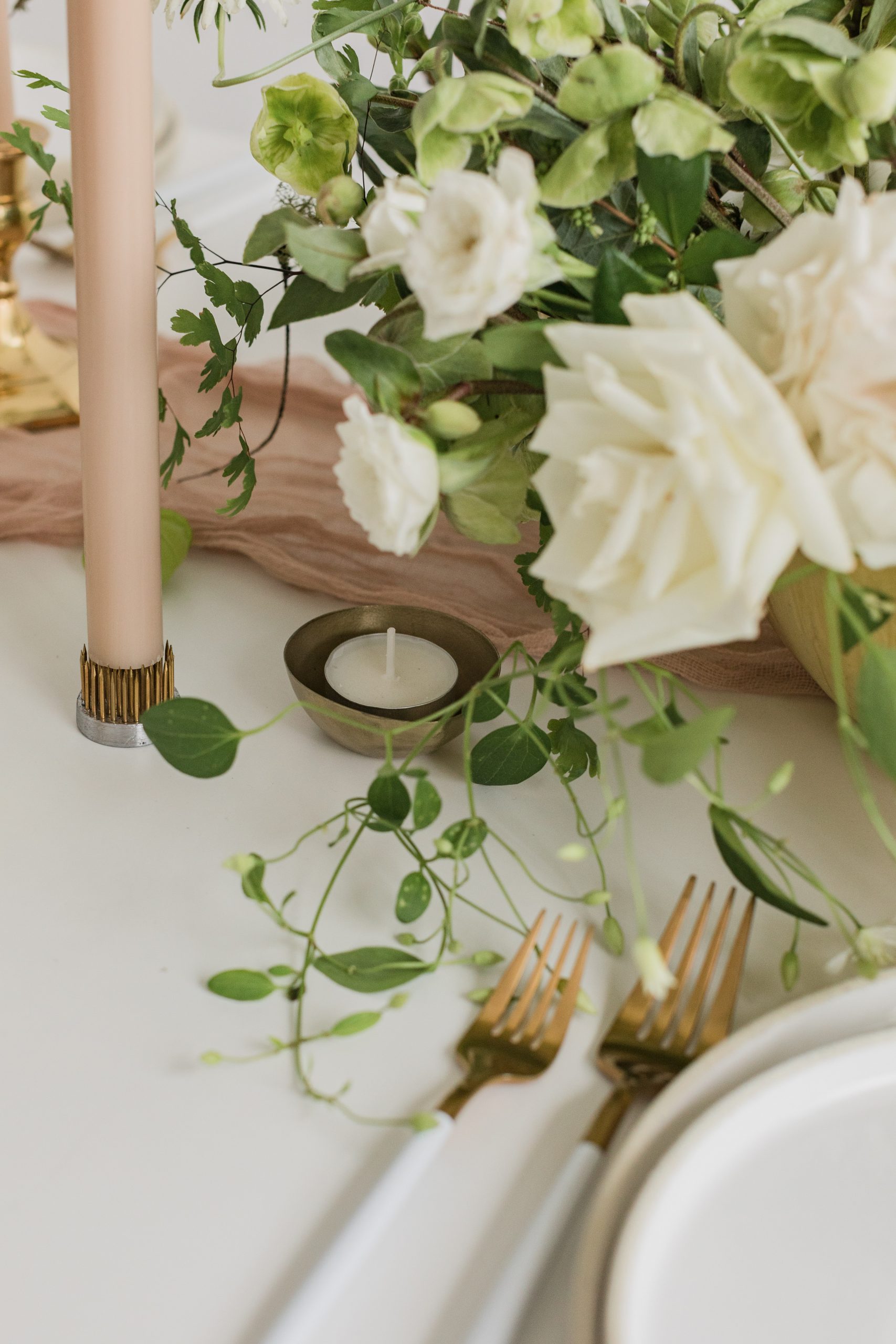 Modern-White-Wedding-Table-Setting-Votives A white wedding table setting with taper and votive candles