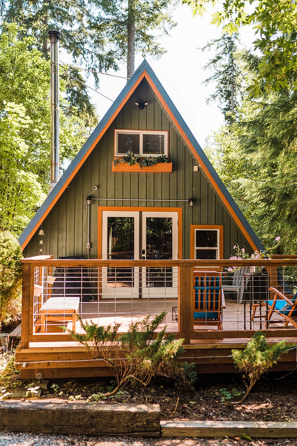 Mountain-Wedding-with-Vibrant-Summer-Blooms-A-Frame-Cabin An A-frame cabin in the woods