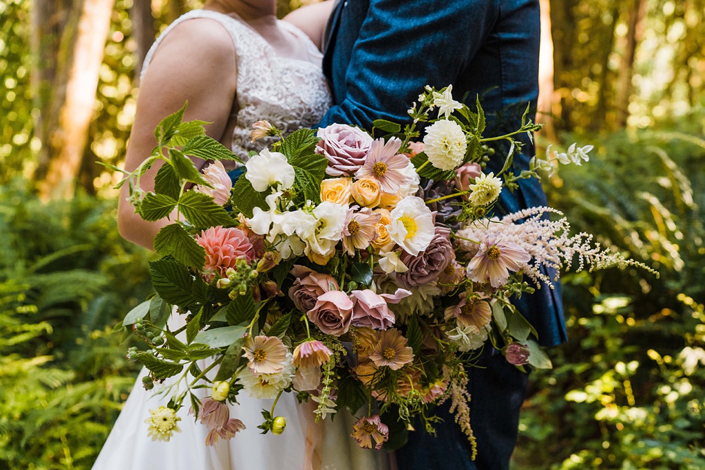 Mountain-Wedding-with-Vibrant-Summer-Blooms-Bridal-Bouquet-Closeup A closer look at the bridal bouquet full of poppies, roses, dahlias, and cosmos