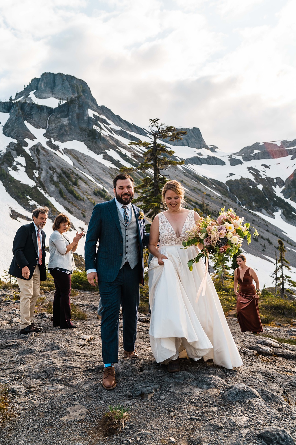 Mountain-Wedding-with-Vibrant-Summer-Blooms-Just-Married-on-Mountain The couple exits their mountaintop ceremony for that just married look!