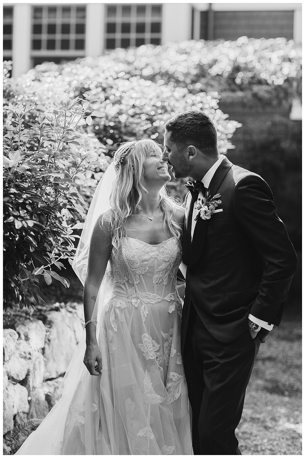 a black-and-white image of the couple kissing