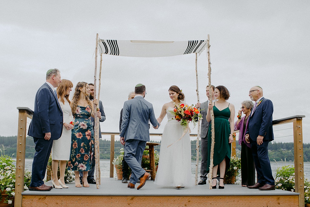 The bride and groom with their human-powered chuppah at Kiana Lodge