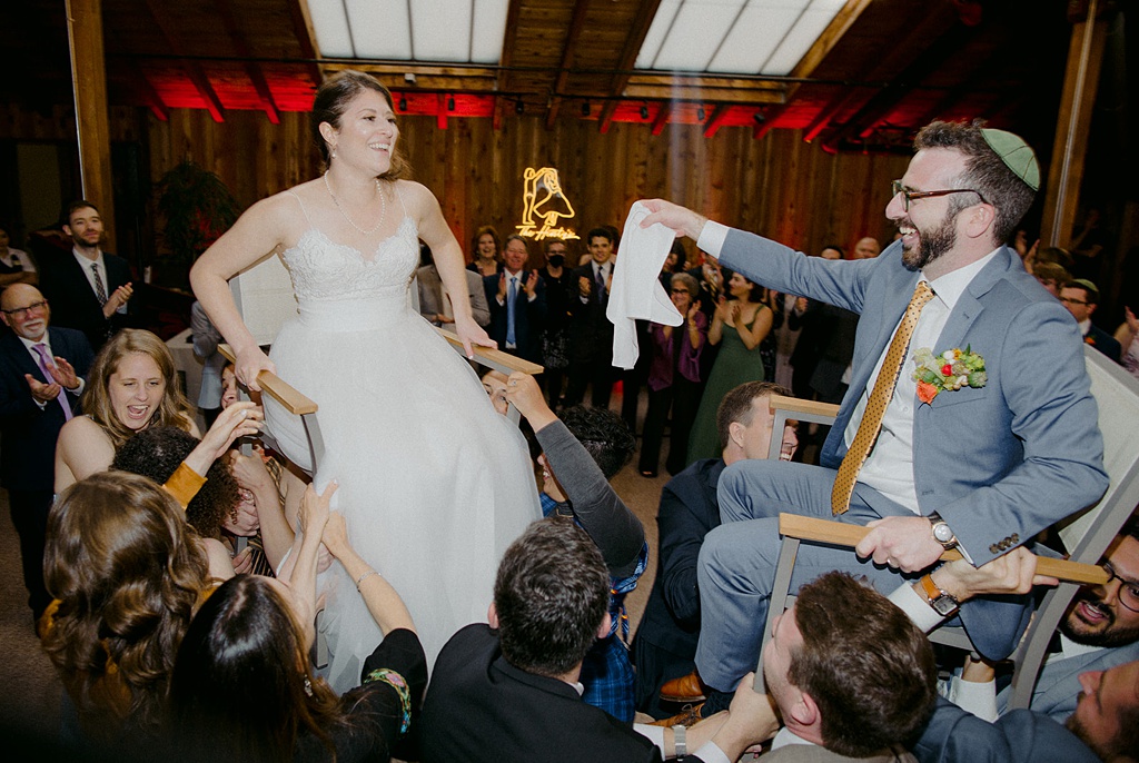 The bride and groom lifted in chairs for the hora