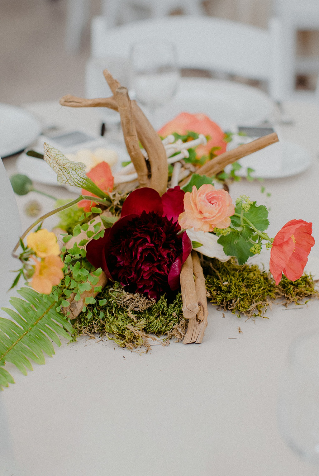 A Kiana Lodge wedding reception centerpiece with a large peony