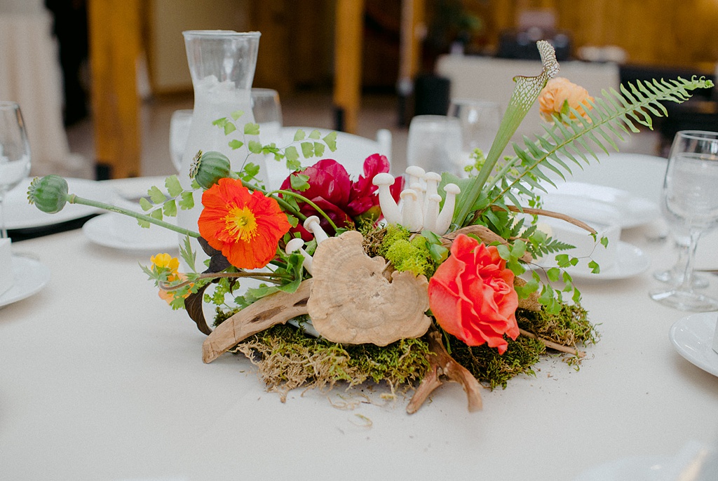 A Kiana Lodge wedding floral centerpiece with mushrooms and poppies