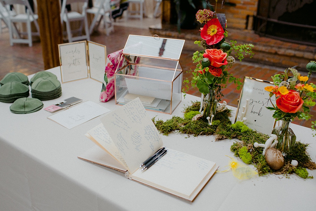 Welcome table with florals and mushrooms
