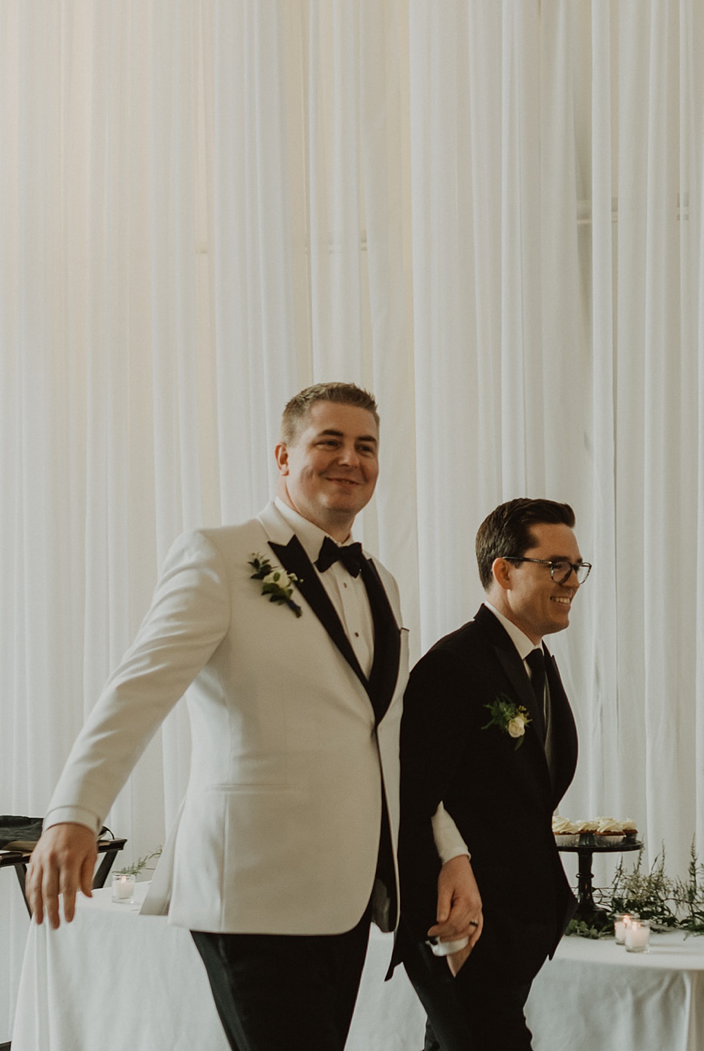 A gay wedding couple entering their reception at Pemberton Farm