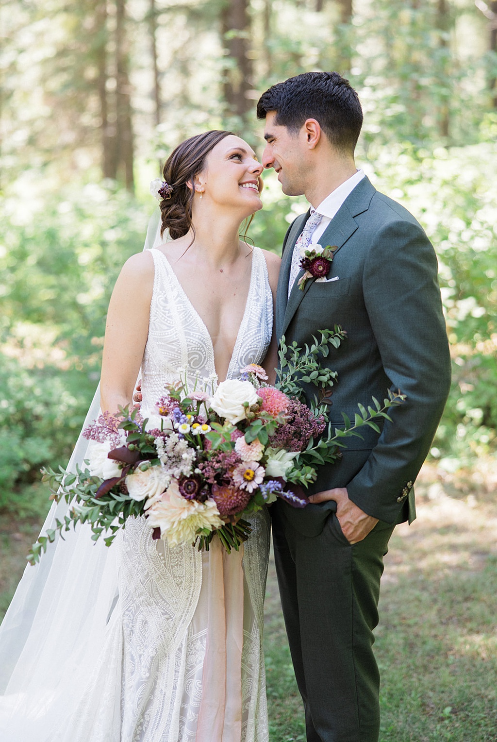 Bloom-Poet-Seattle-Wedding-Florist-Tierra-Retreat-Center-Wedding-Bouquet-with-Roses The bride and groom embrace holding a summer wedding bouquet with roses at the Tierra Retreat Center