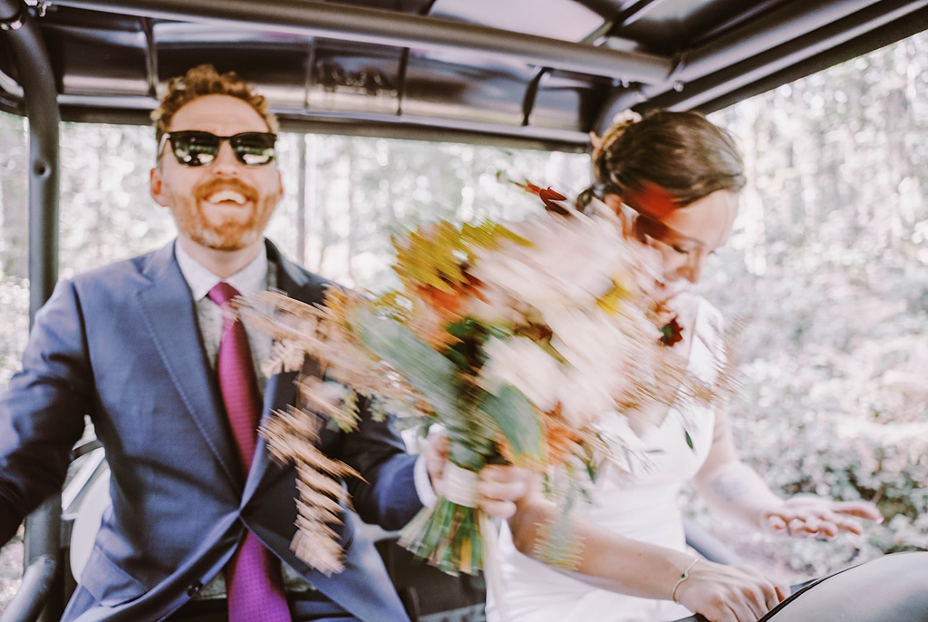 Bloom-Poet-Seattle-Wedding-Florist-Summer-Wedding-4x4-Ride.jpg The groom holds the bouquet while the couple rides on a 4x4