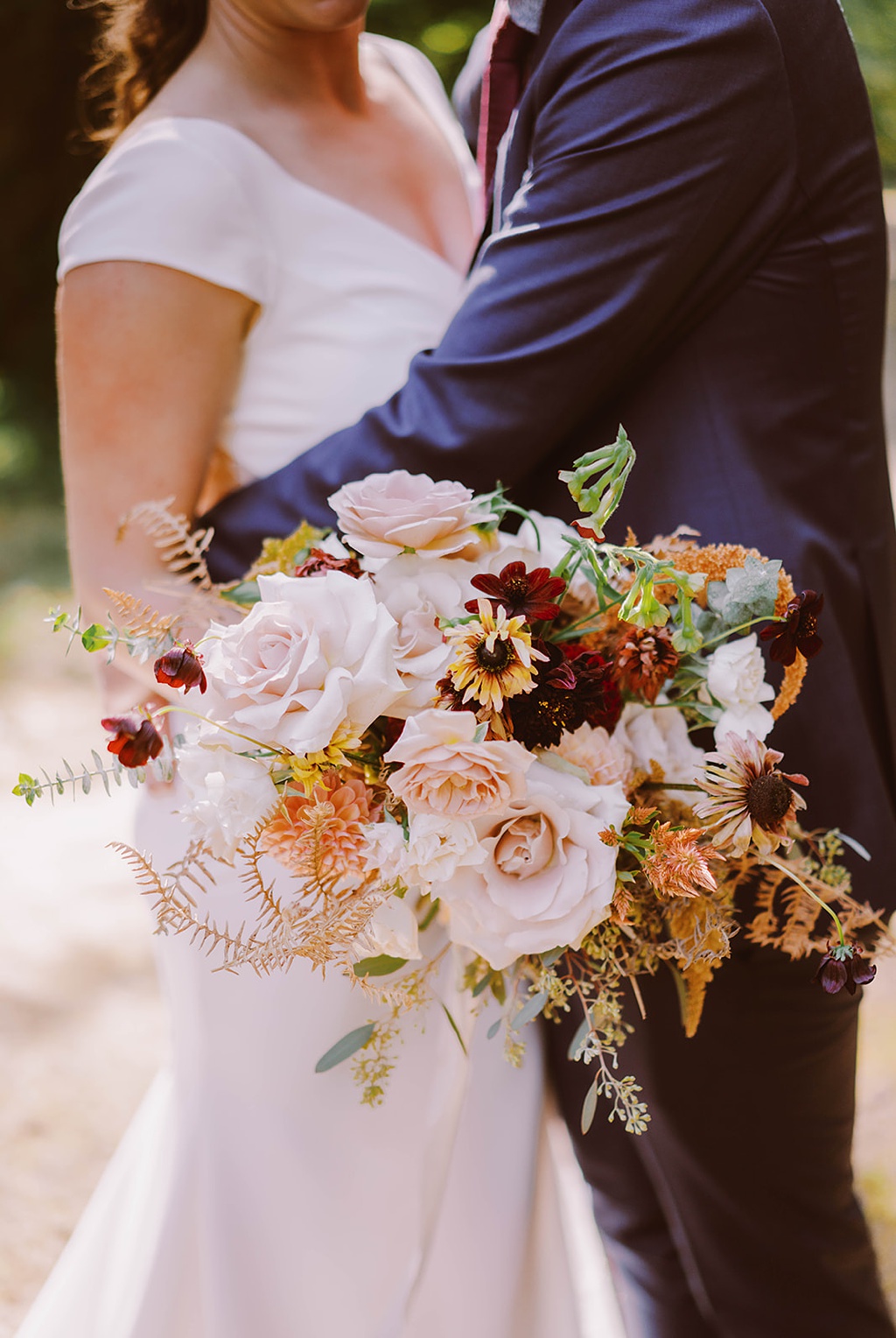 Bloom-Poet-Seattle-Wedding-Florist-Summer-Wedding-Bouquet.jpg The couple holds a wedding bouquet for their late summer wedding