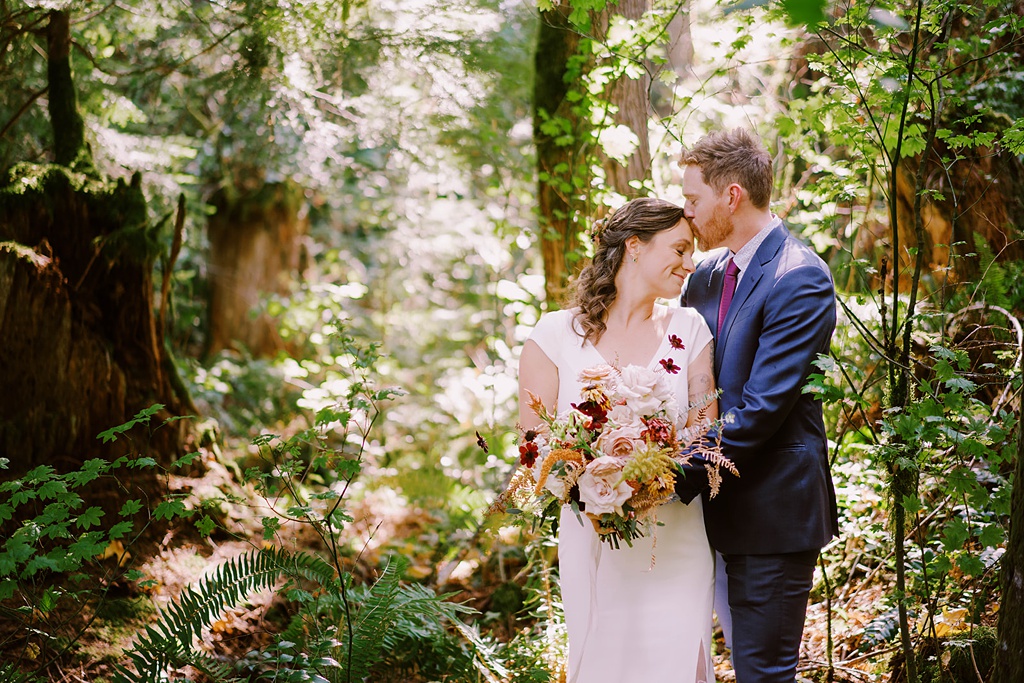 Bloom-Poet-Seattle-Wedding-Florist-Summer-Wedding-Forest-Bouquet.jpg The couple standing in the forest holding the bouquet